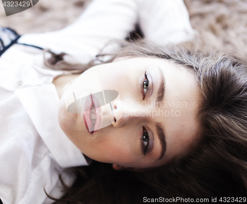 Image of young pretty brunette woman in her bedroom sitting at window, happy smiling lifestyle people concept