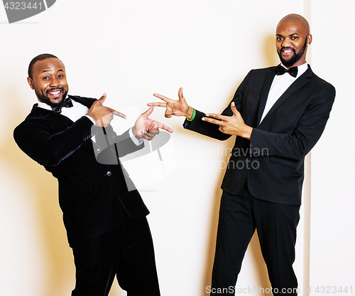 Image of two afro-american businessmen in black suits emotional posing, g