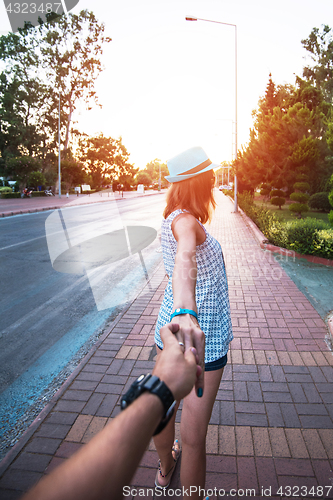 Image of Girl holding a hand man on the street