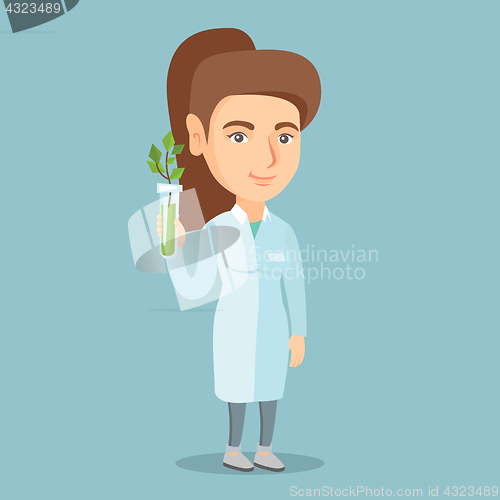 Image of Scientist holding test tube with young sprout.