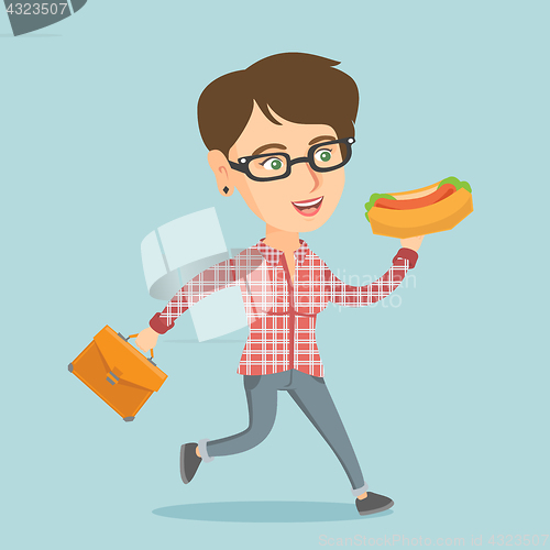 Image of Caucasian business woman eating hot dog on the run