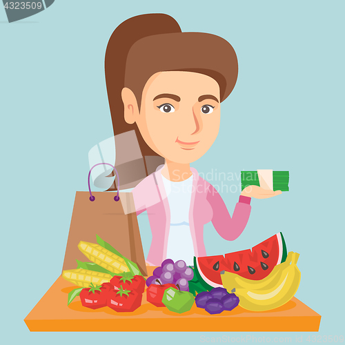 Image of Caucasian woman with money and grocery purchases.