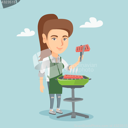Image of Caucasian woman cooking steak on the barbecue.