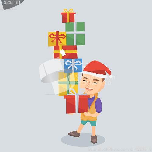 Image of Caucasian boy holding christmas gift boxes.