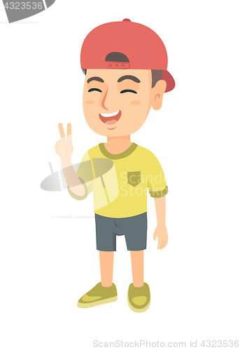 Image of Caucasian little boy showing victory gesture.