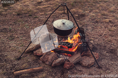 Image of Preparing food on campfire