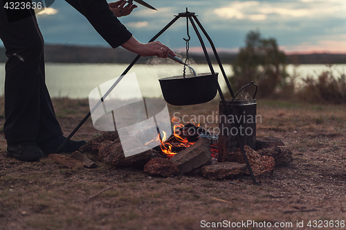 Image of Preparing food on campfire