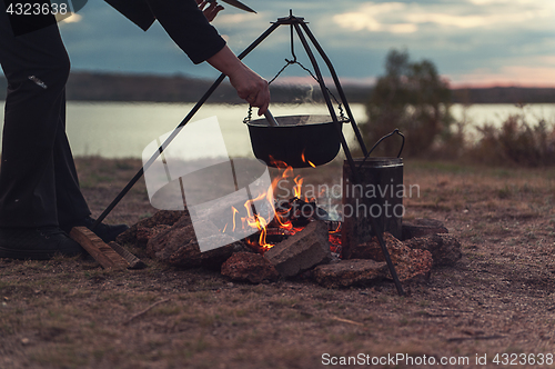 Image of Preparing food on campfire