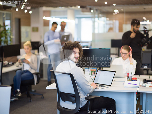 Image of businessman working using a laptop in startup office