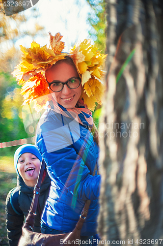 Image of Beauty woman and her son at autumn park