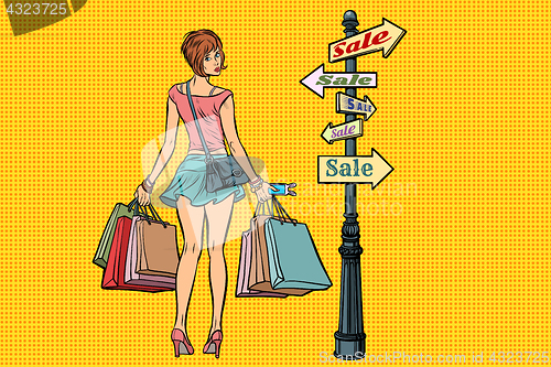 Image of young woman at the sign for sales