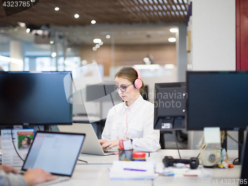 Image of businesswoman using a laptop in startup office