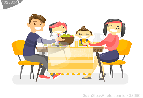 Image of Happy multiethnic family dining at the table.