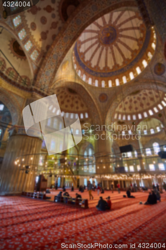 Image of blur image of Muslims praying inside Mosque