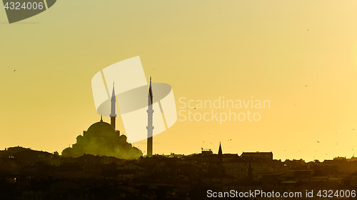 Image of Silhouette of a Mosque Fatih in a fog and sunlight reflections. Vintage style.