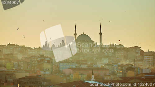 Image of Silhouette of a Mosque Fatih in a fog and sunlight reflections. Vintage style.