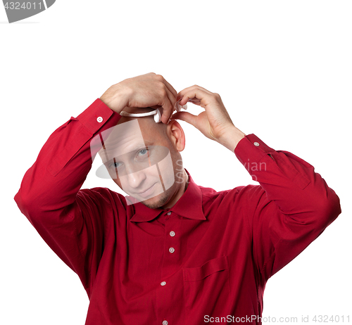Image of Young man in red shirt puts on head headset EEG (electroencephal