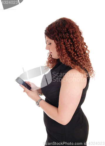 Image of Beautiful woman texting on the phone.