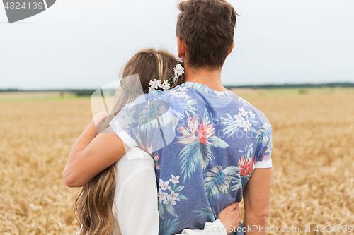 Image of smiling young hippie couple over minivan car