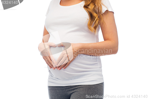 Image of pregnant woman making heart gesture on her belly