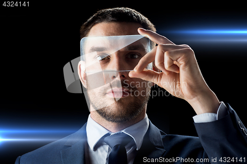 Image of businessman with transparent smartphone