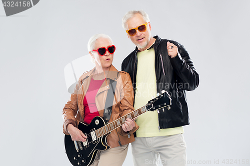 Image of senior couple in sunglasses with electric guitar