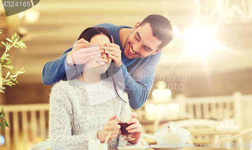 Image of happy couple drinking tea at cafe