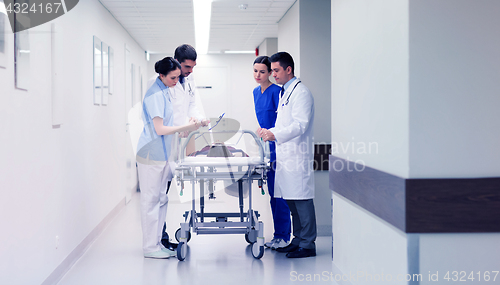 Image of medics with woman on hospital gurney at emergency