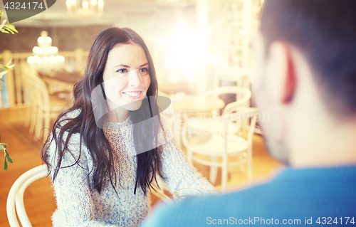 Image of happy couple talking at cafe or restaurant