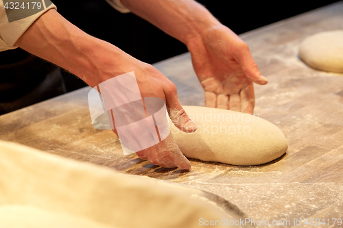 Image of chef or baker cooking dough at bakery