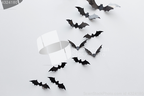 Image of black paper bats over white background