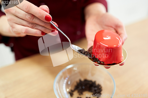 Image of chef decorating mirror glaze cakes at pastry shop