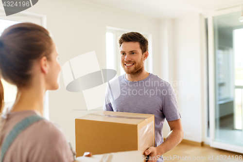 Image of happy couple with boxes moving to new home