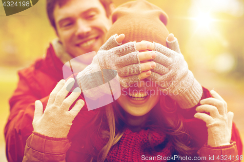 Image of happy young couple having fun in autumn park