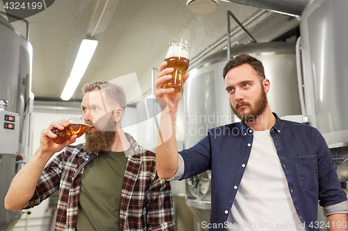 Image of men testing non-alcoholic craft beer at brewery