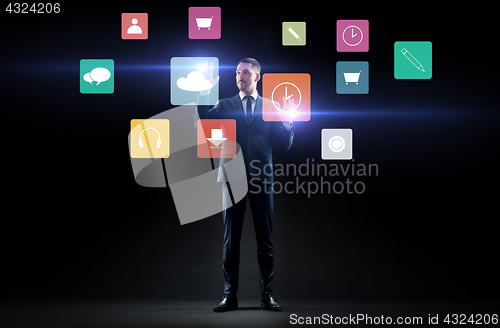 Image of businessman with menu icons on virtual screen