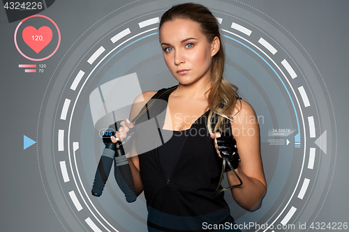 Image of young sporty woman with jumping rope and pulse