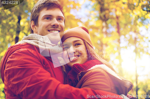 Image of happy young couple hugging in autumn park