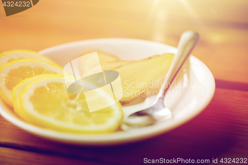 Image of lemon and ginger on plate with spoon