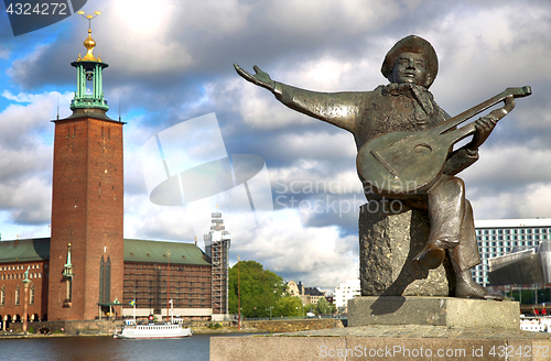 Image of Evert Taube monument on Gamla Stan and City Hall in Stockholm, S