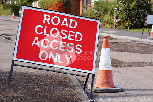 Image of ROAD CLOSED ACCESS ONLY road sign with a traffic cone