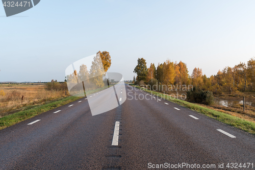 Image of Straight road into a colorful landscape