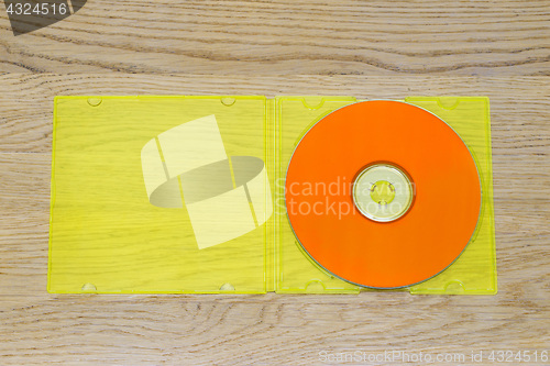 Image of Listen to the music, orange cd and yellow plastic case