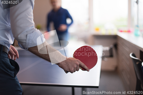 Image of startup business team playing ping pong tennis