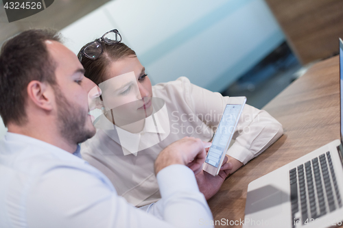 Image of Business People Working With Tablet in startup office