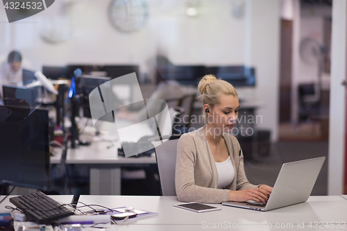 Image of businesswoman using a laptop in startup office