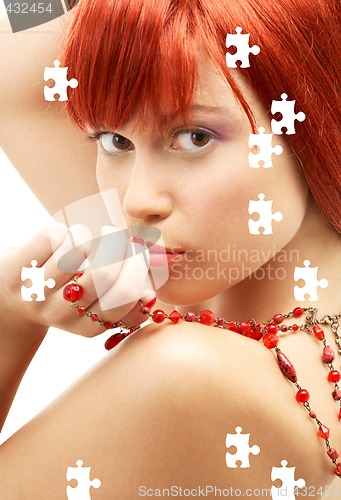 Image of puzzle of redhead with red beads looking over shoulder