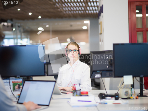 Image of businesswoman using a laptop in startup office