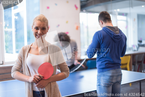 Image of startup business team playing ping pong tennis