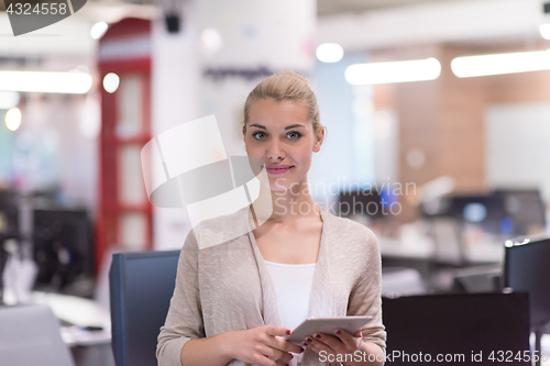 Image of Business Woman Using Digital Tablet in front of startup Office